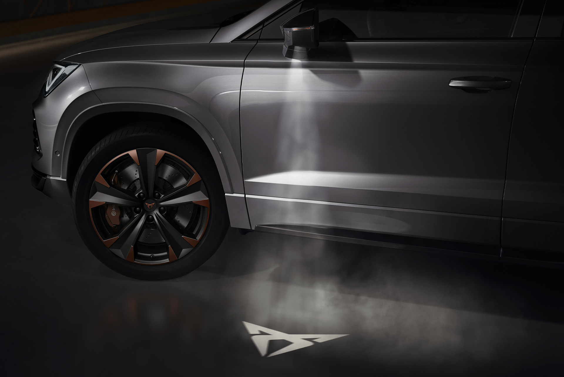 CUPRA logo projected onto the ground from the CUPRA Ateca, representing the connection with the CUPRA Tribe.